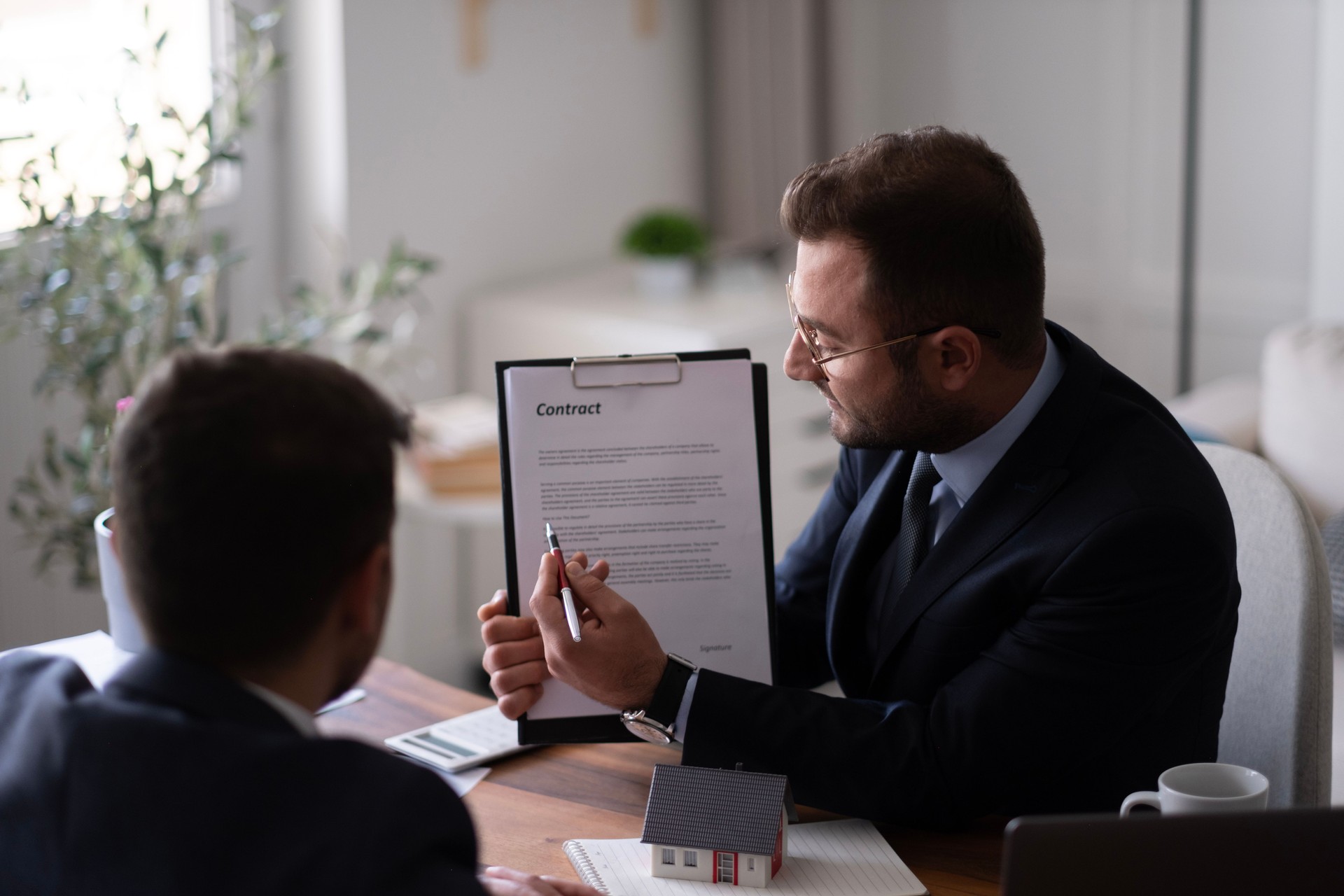 Estate agent shaking hands with his customer after contract signature